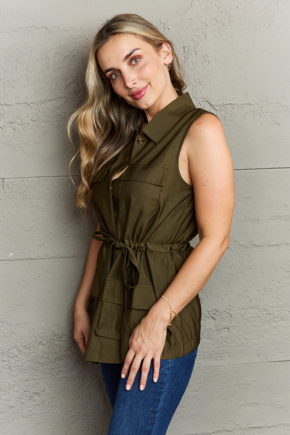 The Light Sleeveless Collared Button Down Top